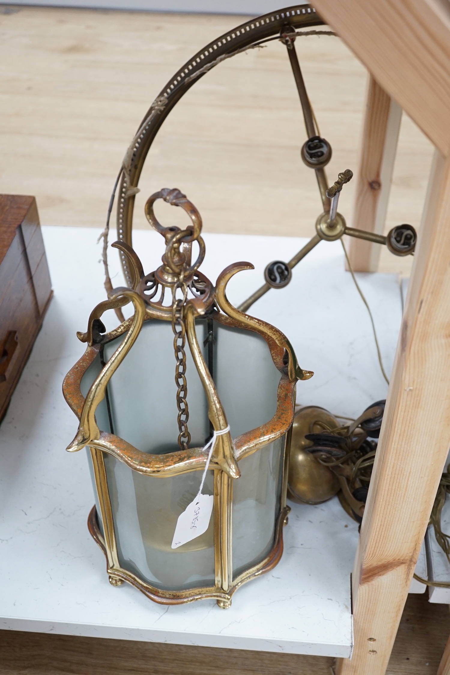 A brass hall lantern and a circular brass ceiling light fitting, hall lantern 40 cms high.